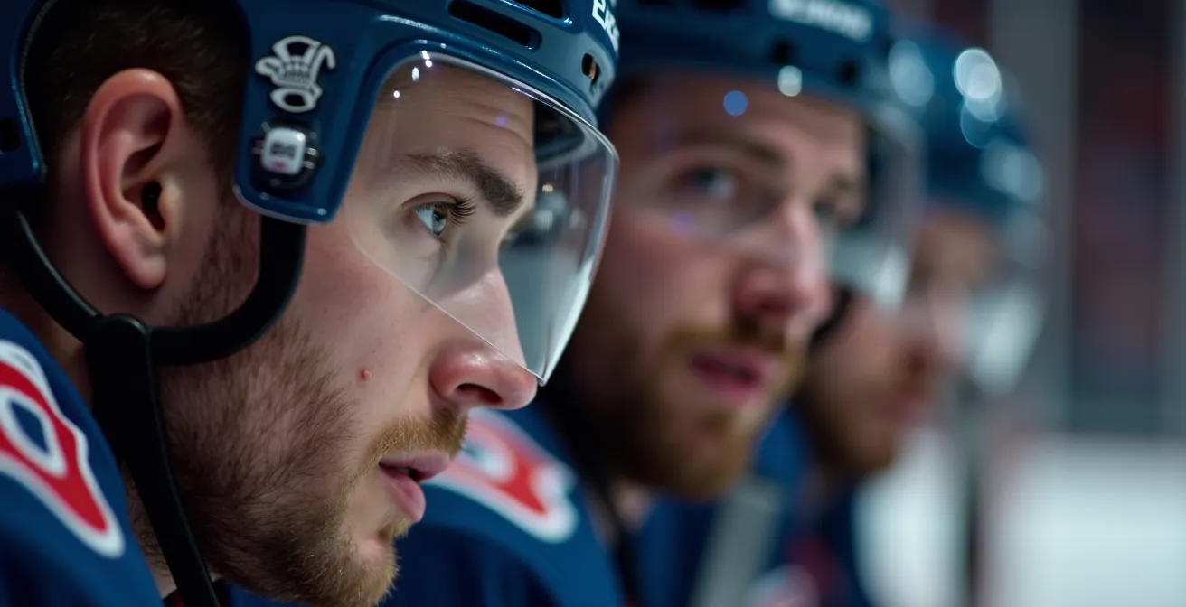 Trainer beruhigt erhitzten Spieler zwischen den Einsätzen auf der Spielerbank